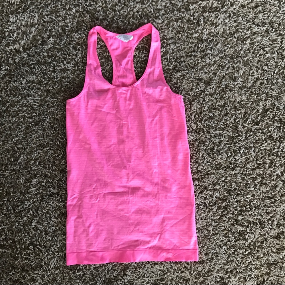 Fitted pink Under Armour tank top.